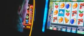 A Person Playing on a Slot Machine