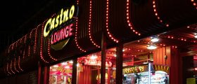 A Booth with Vending Machines and a Large Sign Reading Casino Lounge