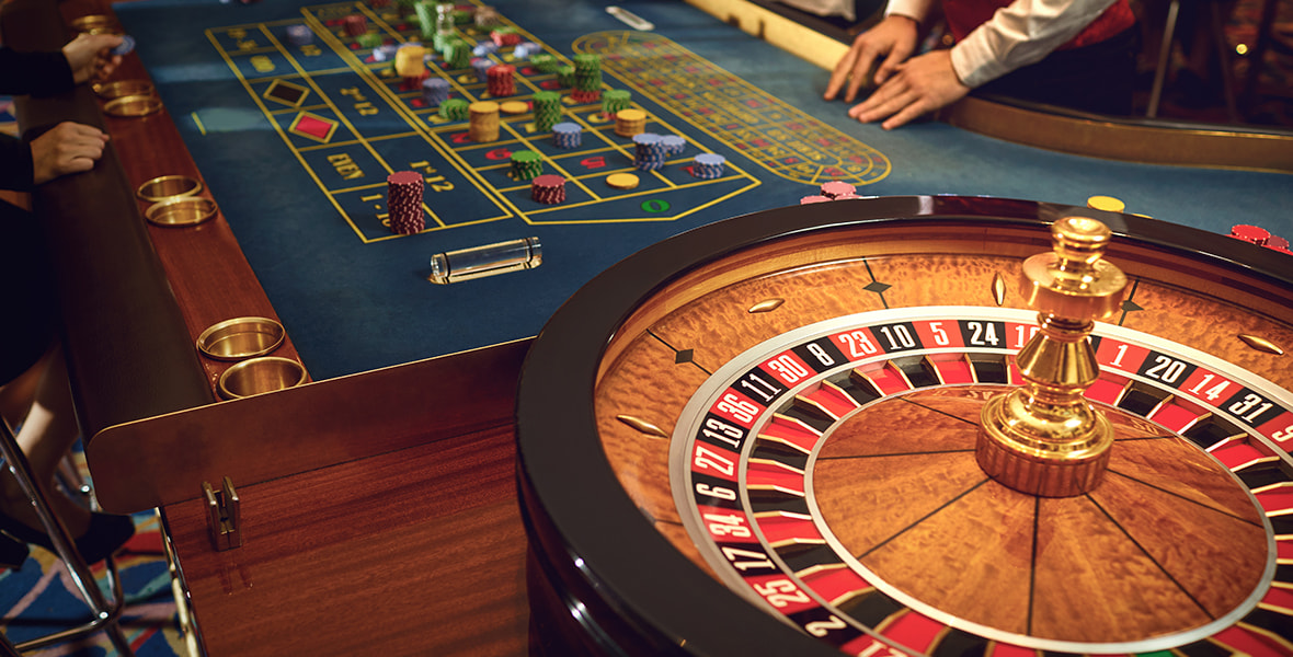 Large Table Containing Poker Chips and a Roulette Board 