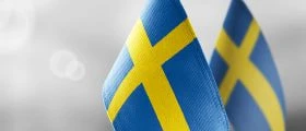 The Swedish national flags on a blurry grey background.