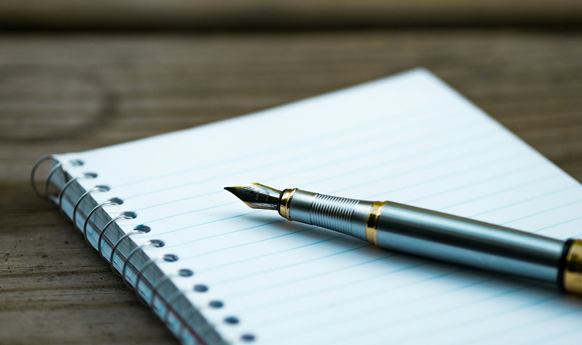 A Fountain Pen on A Book Left on a Desk 