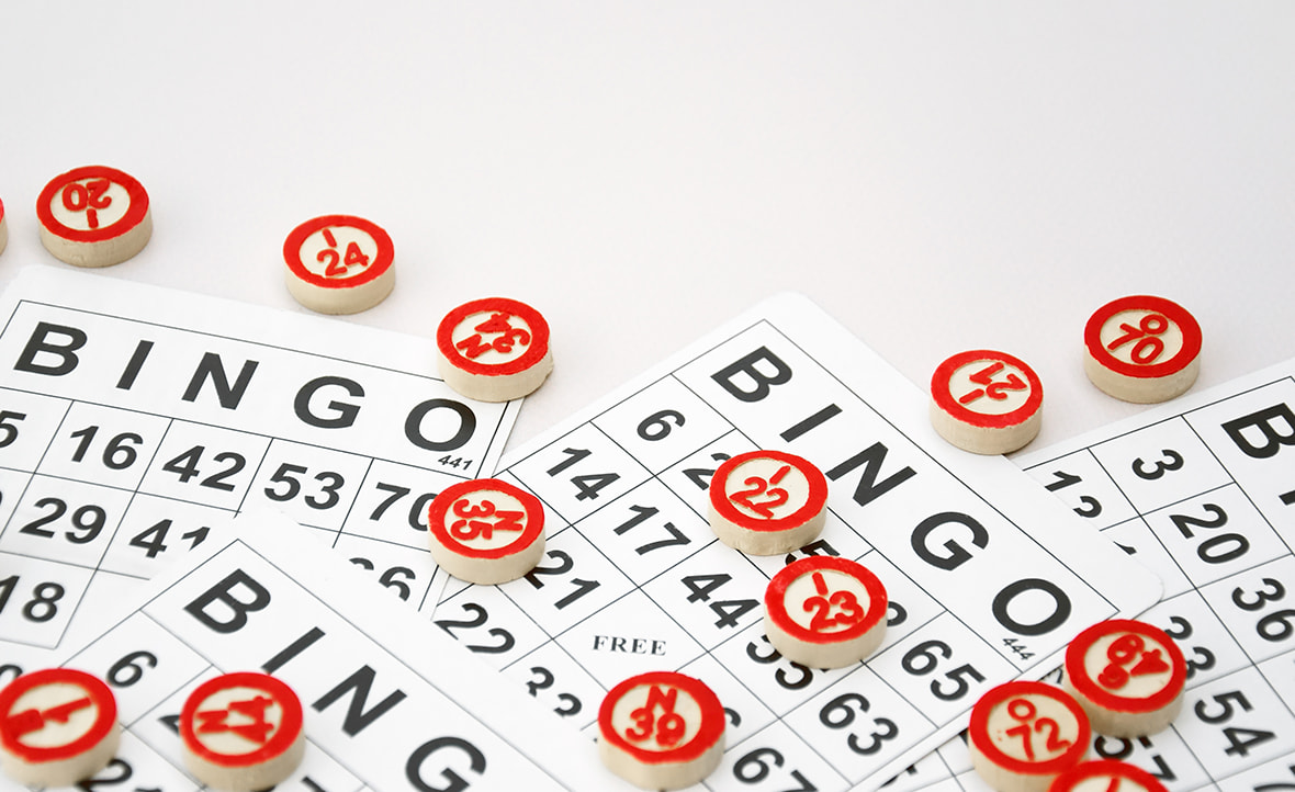 Numbered Wooden Chips Placed on Top of Bingo Tickets. 